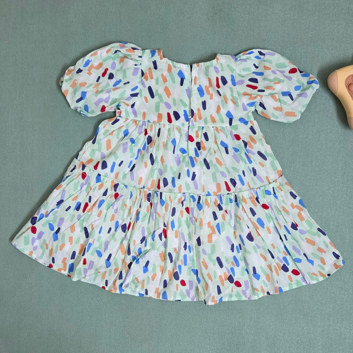 Colorful patterned dress on a gray background