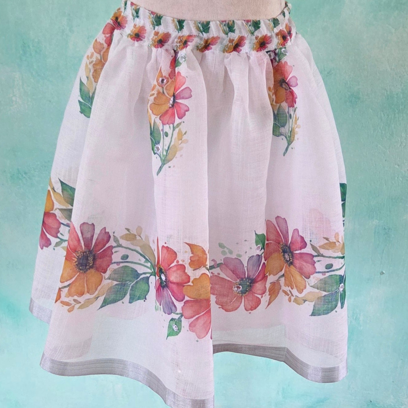 Floral skirt on a mannequin against a light blue background