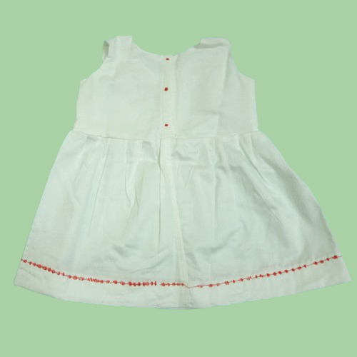 back view of White dress with red trim on a light green background