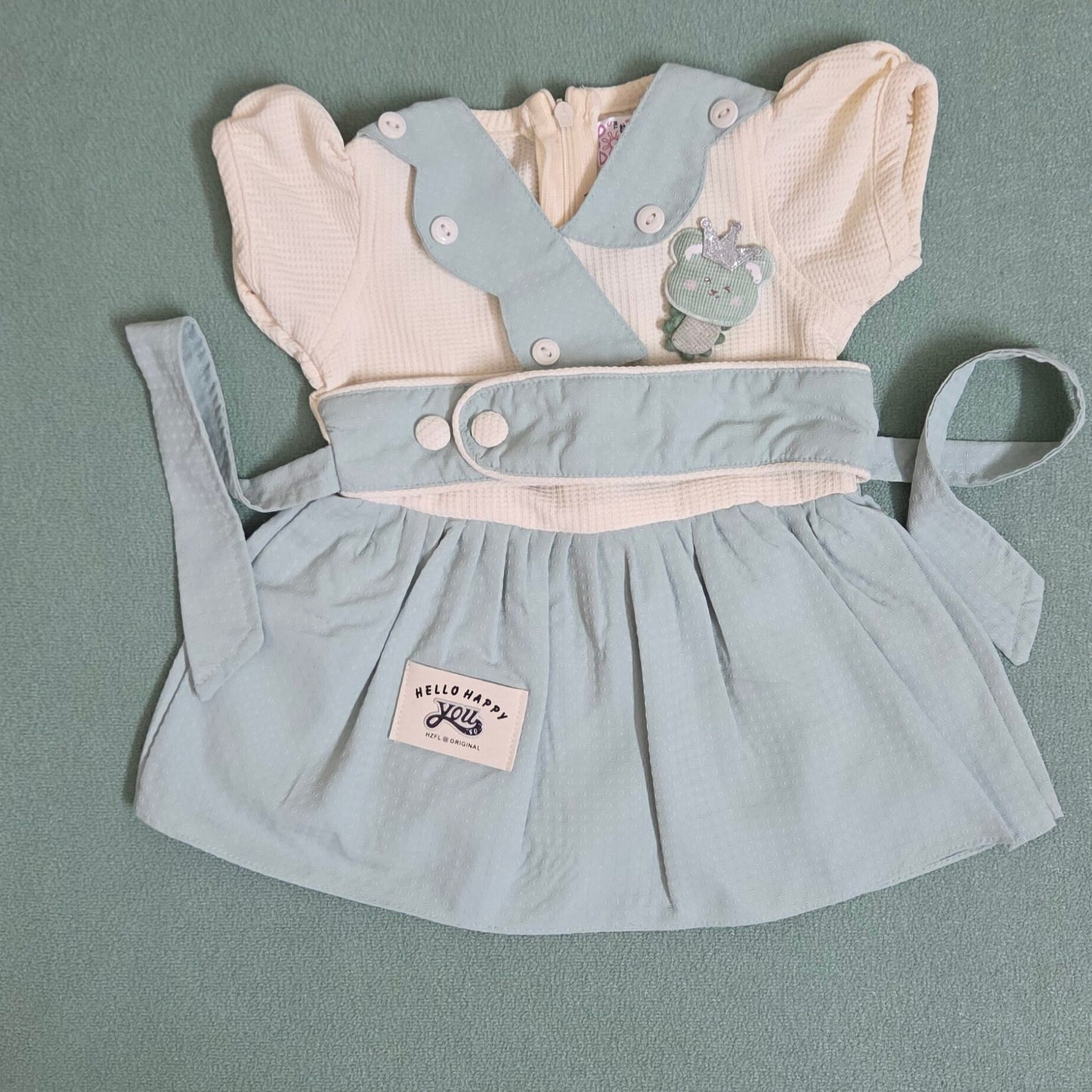 Light blue dress with white shirt and bear design on a gray background