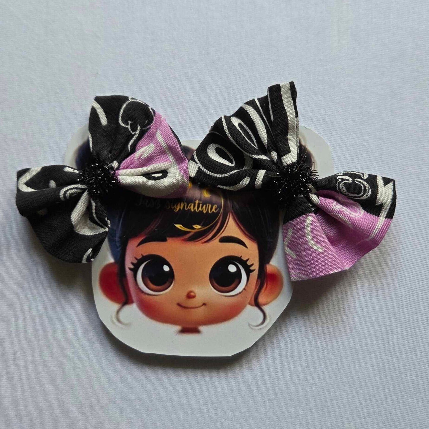 Hair accessories with cartoon character design on a light gray background