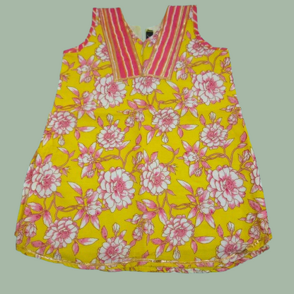 Yellow dress with pink floral pattern on a light green background