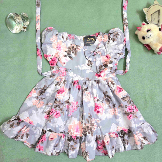 Floral dress with a bow on a green surface