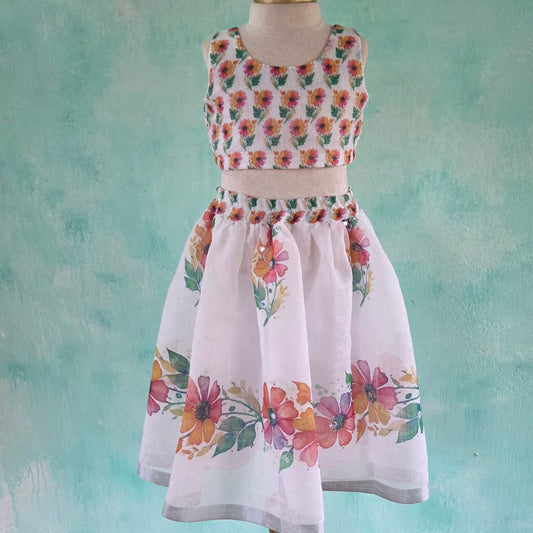 Floral dree on a mannequin against a textured teal background