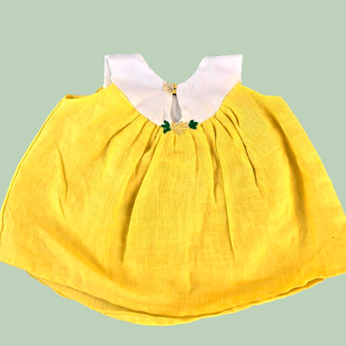 Yellow dress with white collar on a light green background