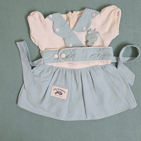 Light blue dress with white shirt and bear design on a gray background