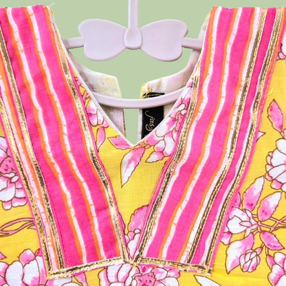 Colorful striped dress with floral patterns on a hanger against a light green background